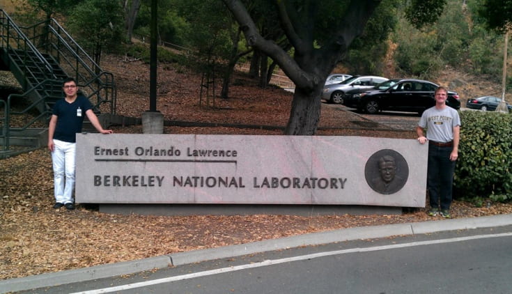 Two guys standing infrontof Berkely National Laboratory sign